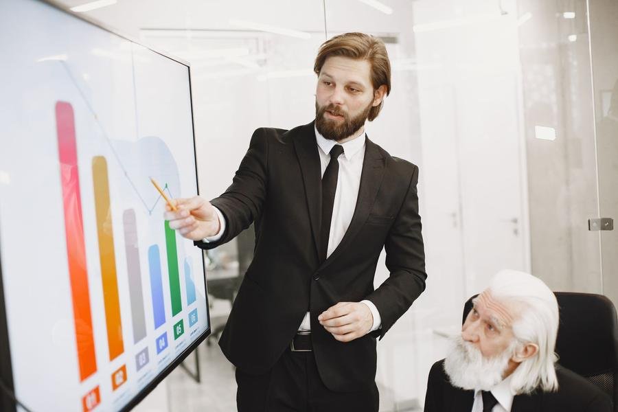 UK business advisor presenting a growth chart to a client in an office