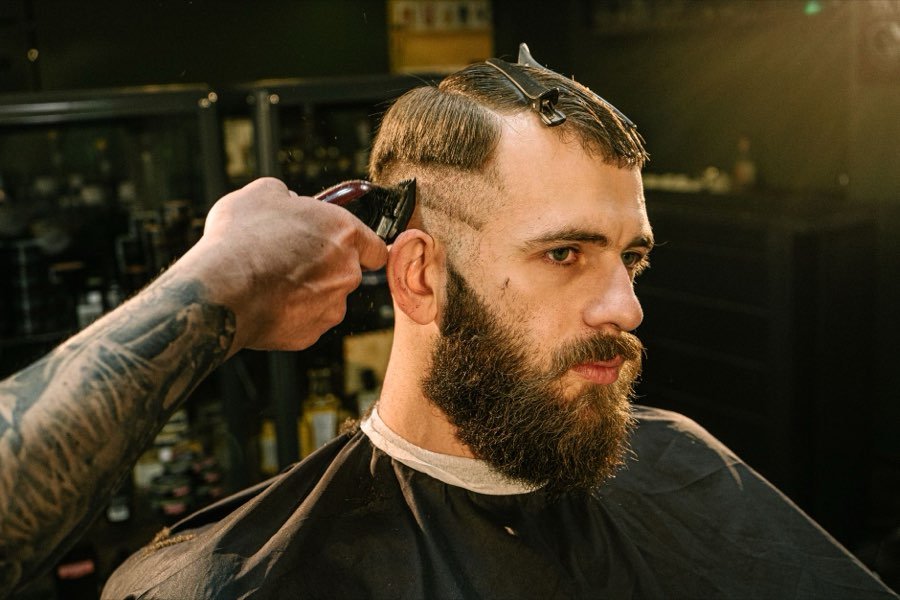 UK barber giving a client a skin fade with clippers