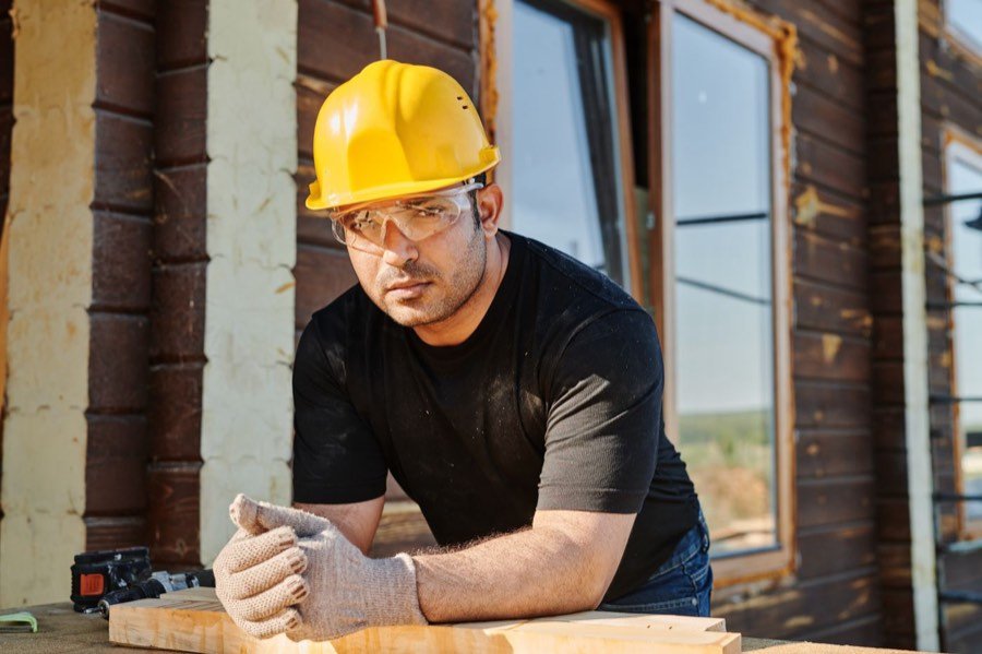 UK builder working on a timber build on a construction site