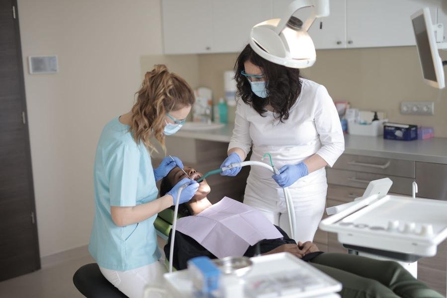 Two UK dental clinicians working together on a patient