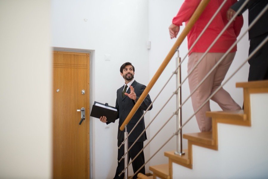 UK estate agent guiding buyers through a property viewing