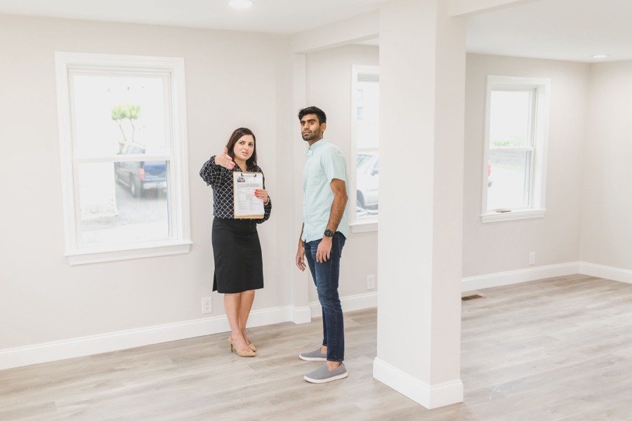 UK estate agent showing a buyer around an empty home