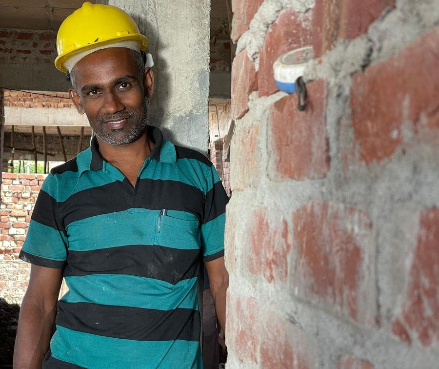 Experienced UK HVAC installer smiling on a job site
