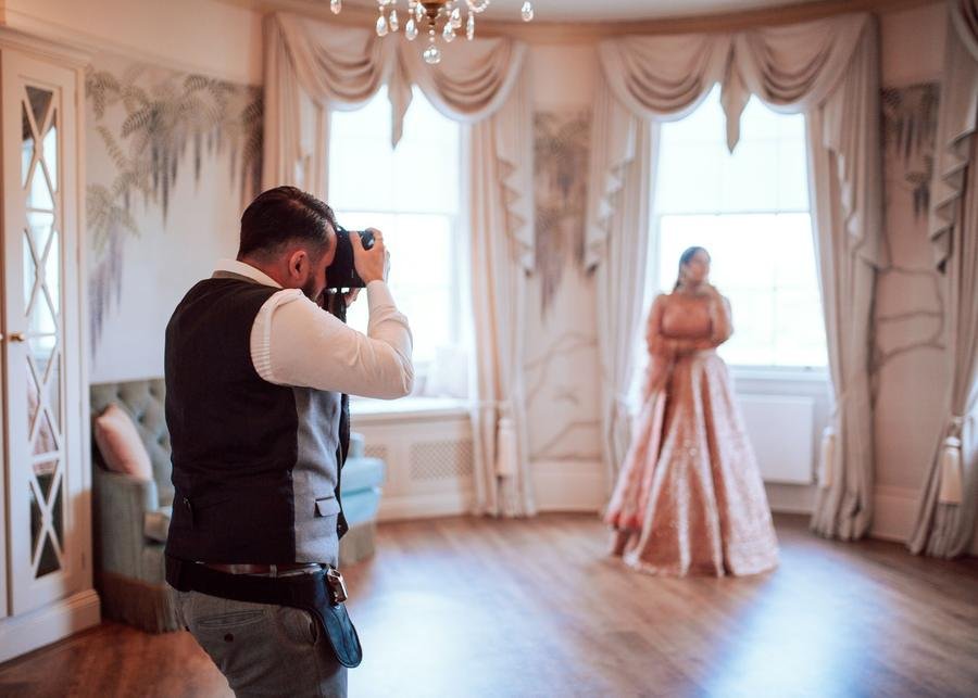 Wedding photographer at work photographing a bride in a UK venue