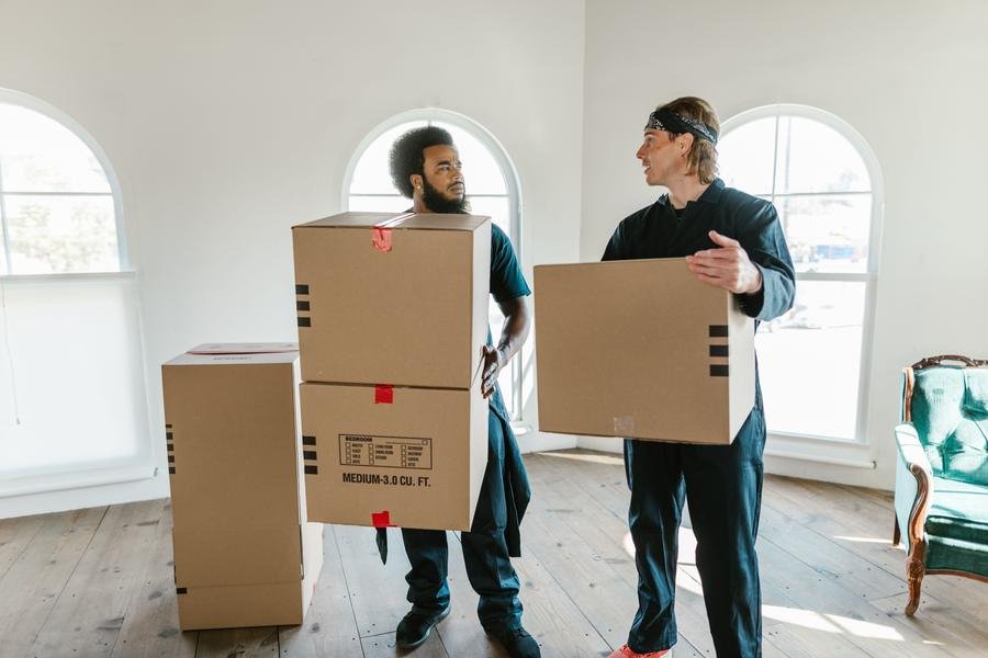 UK removals team carrying boxes on moving day