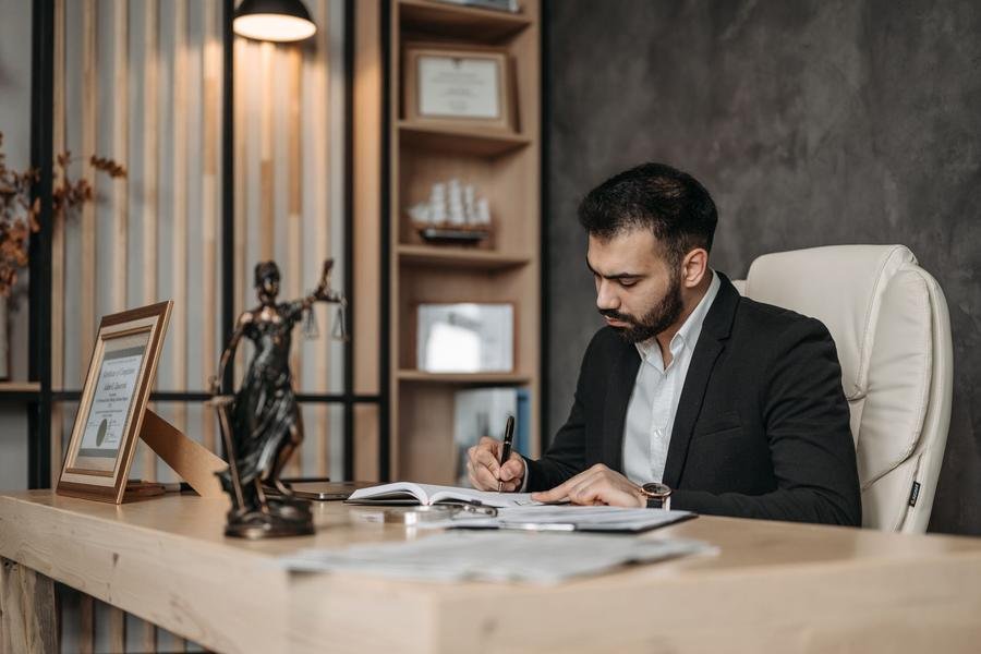UK solicitor signing legal paperwork at a desk